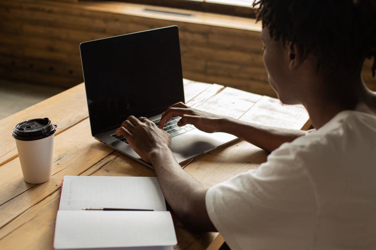 A reviewer comparing notes at a laptop with a coffee, weighing an online verdict