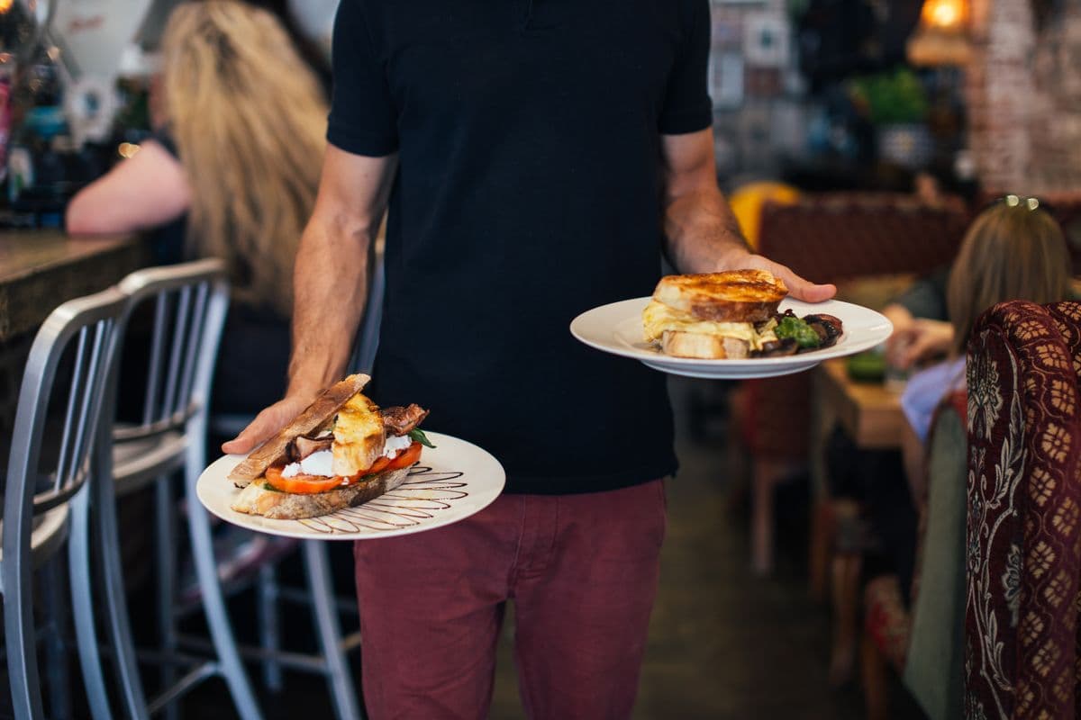 A waiter serving diners