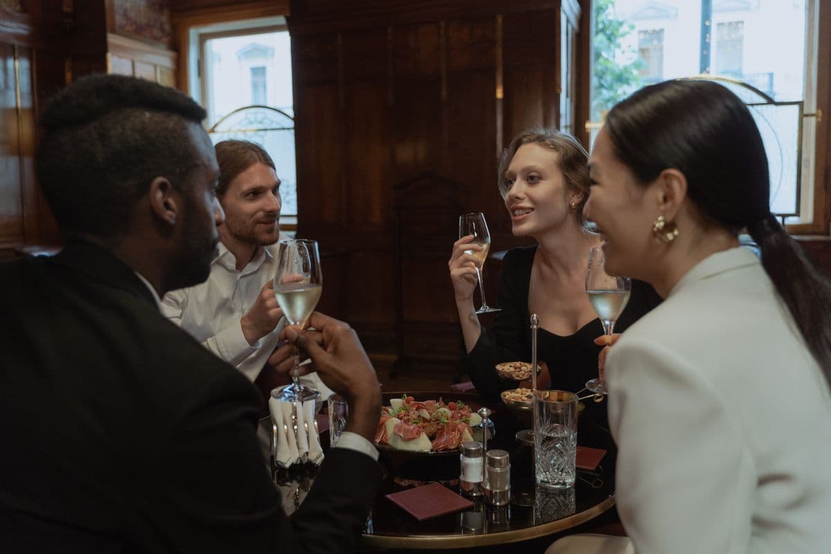 Friends laughing at a dinner table